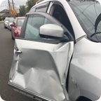 The passenger side door of a vehicle, damaged from an accident.